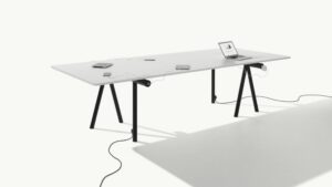 Modern table design with tripod legs and electrical outlets incorporated. 